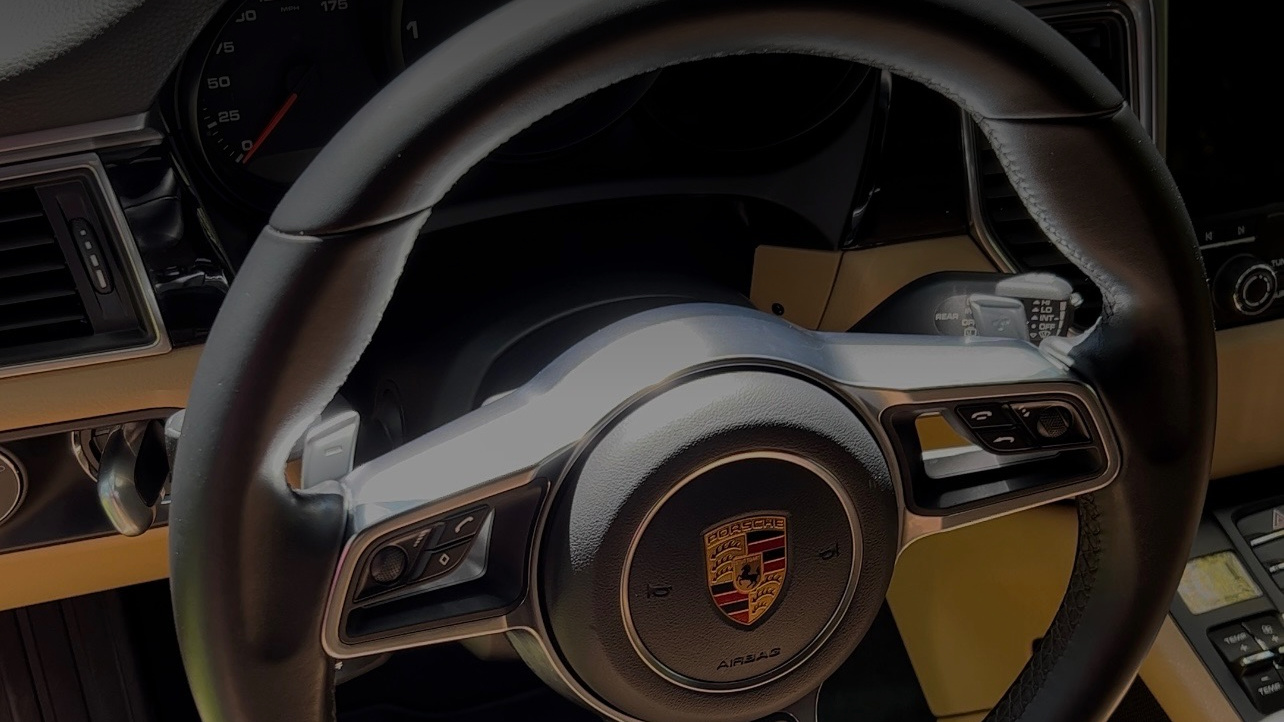 Porsche interior and steering wheel after professional mobile detailing in King William, TX